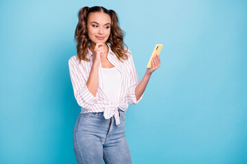 Photo portrait happy girl keeping cellphone browsing information internet isolated vibrant blue color background