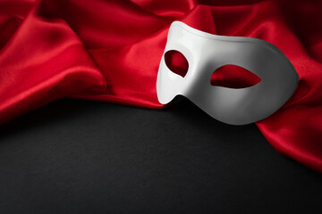White theatre mask and red fabric on black background. Space for text - obrazy, fototapety, plakaty