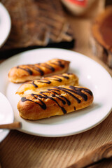 Closeup on a plate of sweet baked chocolate eclairs