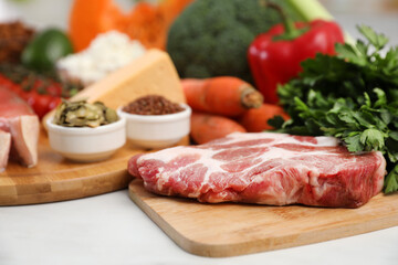 Fresh meat and parsley on white table, space for text. Keto diet