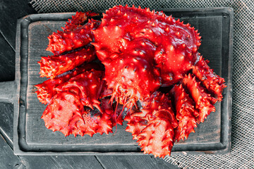 Spiny crab on a wooden server board. 