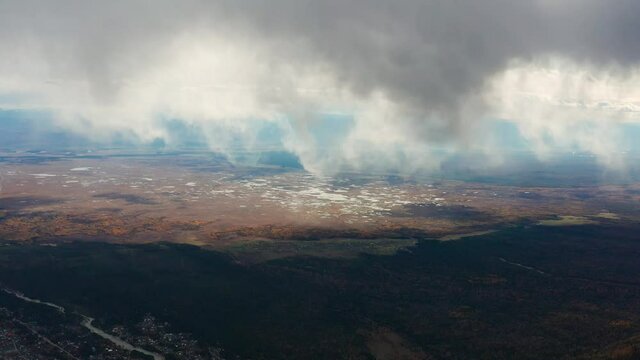 Eastern Sayans in autumn. Tunka valley before the rain. Low cloud cover.