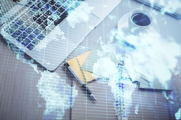 Business theme hologram drawings over computer on the desktop background. Top view. Multi exposure. Concept of international connections.