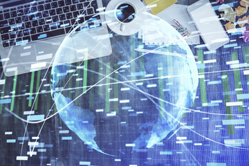 Business theme hologram drawings over computer on the desktop background. Top view. Multi exposure. Concept of international connections.