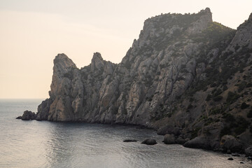 Fototapeta na wymiar Stone rock on the coast of the peninsula in Alanya (Turkey) - view from the sea.
