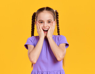 Amazed girl in casual dress looking at camera