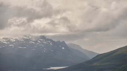Obraz premium Scenic view of clouds and mountains near Tromso
