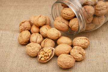 Organic walnuts on burlap. Food background.