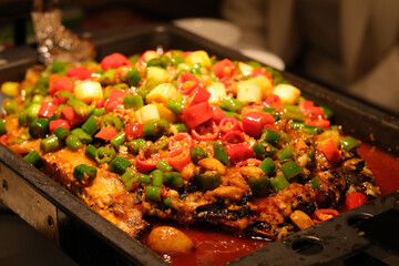 close up spicy grilled fish with colorful peppers. Chinese food