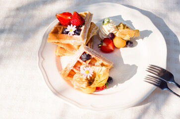 Homemade breakfast  Strawberry and tropical fruits  Waffles with  chocolate syrup 