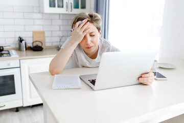 tired woman in stress working on laptop