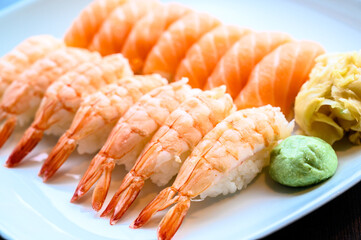 Plate of fresh sushi nigiri with wasabi and ginger