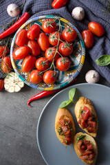Bruschetta with tomatoes and basil on garlic bread. Top view photo of freshly made tomato Italian toasts. Vegetarian meal photo.  Healthy eating concept. 