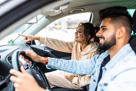 Enjoy Life Fun Indian Couple Driving Car At High Speed And Point Fingers Forward.