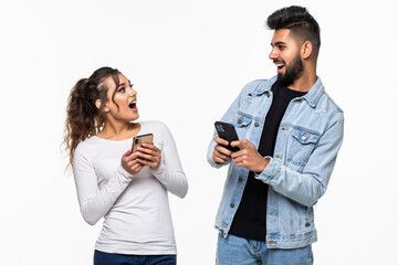 Indian couple, woman spying looking at her boyfriend phone isolated on white background