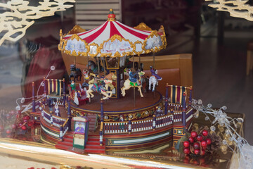 Christmas background with the new year toys, carousel horses, presents and decorations