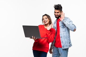 Young indian couple with laptop make video call on white background