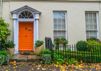 house facade with orange front door and front garden