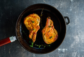Roasted pork meat in the skillet. Selective focus. Shallow depth of field.