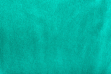 Green homogeneous fleece background. Textile surface. Cloth.