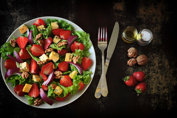 Healthy salad plate with strawberries and cheese. Diet food. Keto salad.