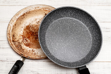 Comparison of pans. Old and new frying pan. New and old damaged non-stick coating.