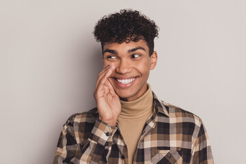 Photo of guy palm mouth look side empty space cunning wear plaid shirt rollneck isolated grey color...
