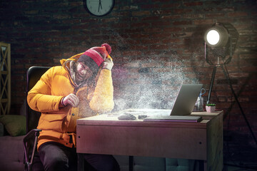 Young man in bright yellow puffy jacket meeting winter on virtual video call.