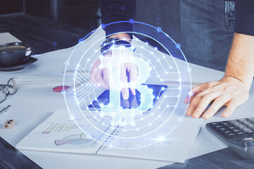 Double exposure of man's hands holding and using a phone and crypto currency blockchain theme...