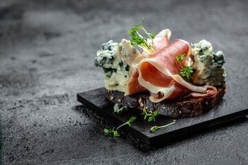 Appetizers. Sandwich with prosciutto and blue cheese. antipasti with red wine. banner, menu recipe...