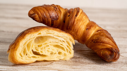 Golden fresh croissants on wooden table. Breakfast with fresh croissants