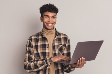 Photo portrait of young boy in checkered shirt browsing internet with laptop studying isolated on...