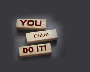 YOU CAN DO IT word on wooden blocks on gray background. Motivation affirmation encouraging words...