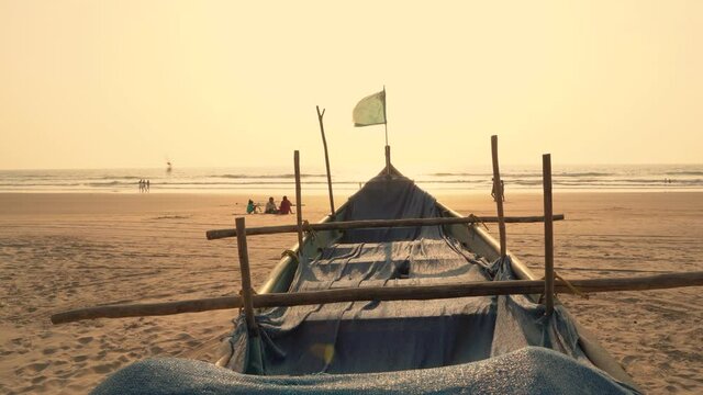 Dramatic view of a boat on beachside during sunset time