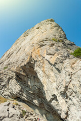 High rock and in foreground in Crimea. Sunny autumn day. Front view.