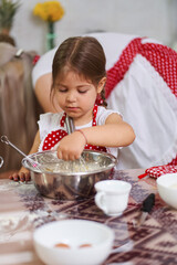 Little girl helping in the kitchen