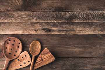 Rustic wood kitchen table background for product montage. Utensils collection on boards top view.	