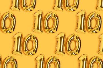 Numbers 10 golden balloons pattern. Ten years anniversary celebration layout on a yellow backdrop.