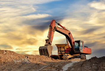 Mobile Stone Jaw crusher machine and excavator during crushing concrete on construction site....
