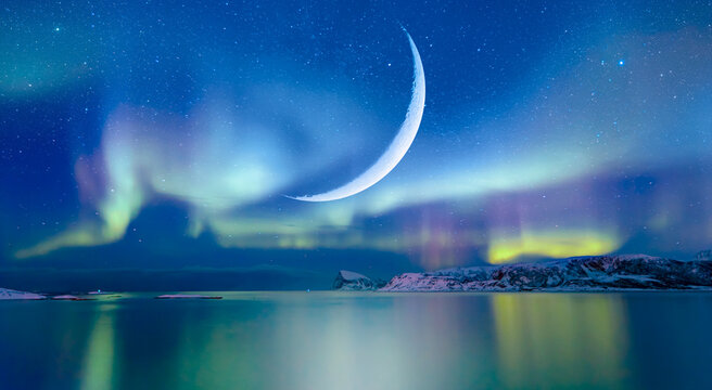Northern lights (Aurora borealis) in the sky with crescent moon - Tromso, Norway "Elements of this image furnished by NASA"