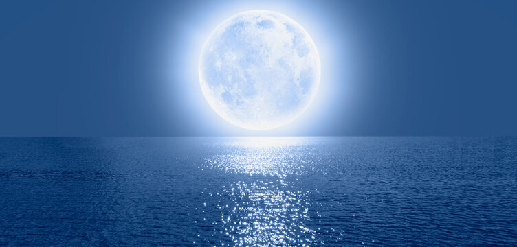 Full moon rising over empty ocean at night, calm sea wave in the foreground"Elements of this image furnished by NASA"