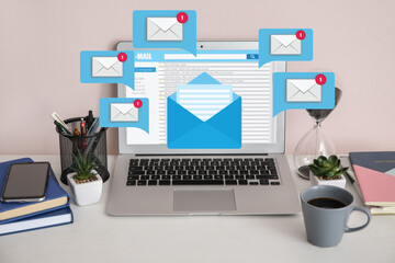 Received email messages on screen of laptop at workplace