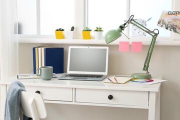Stylish workplace with laptop in office
