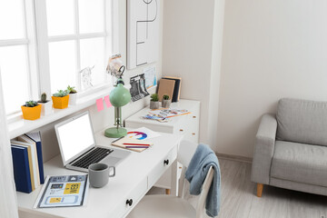 Fototapeta na wymiar Stylish workplace with laptop in office