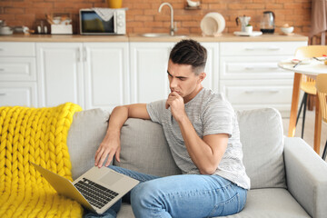 Young man asking psychologist for advice online at home