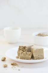 Pieces of sunflower halva on a white plate.