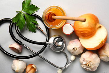 Healthy products with stethoscope on light background