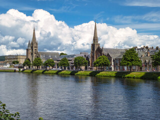 Fototapeta na wymiar View along the bank of the River Ness with St. Columba High Church and Free North Church in Inverness, Scotland.