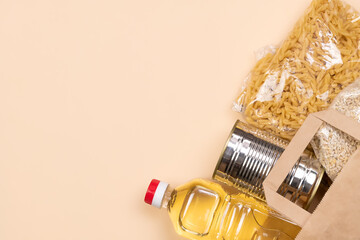 Paper bag with food supplies crisis food supply on a light yellow background, copy space. Pasta,...