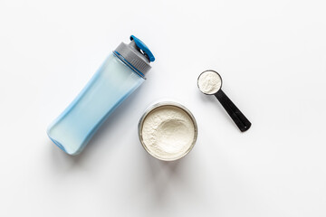 Whey protein powder in scoop and shaker with sport nutrition